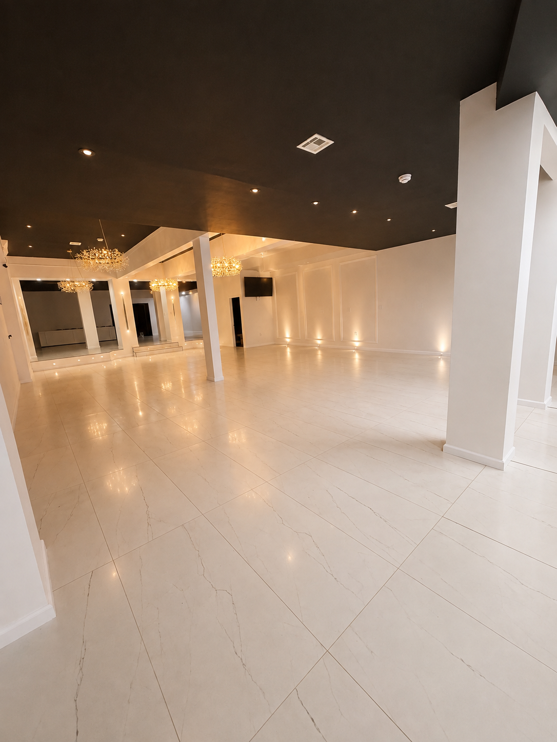 The NOVA 178 event hall lit in warm gold with gallery artwork and set tables